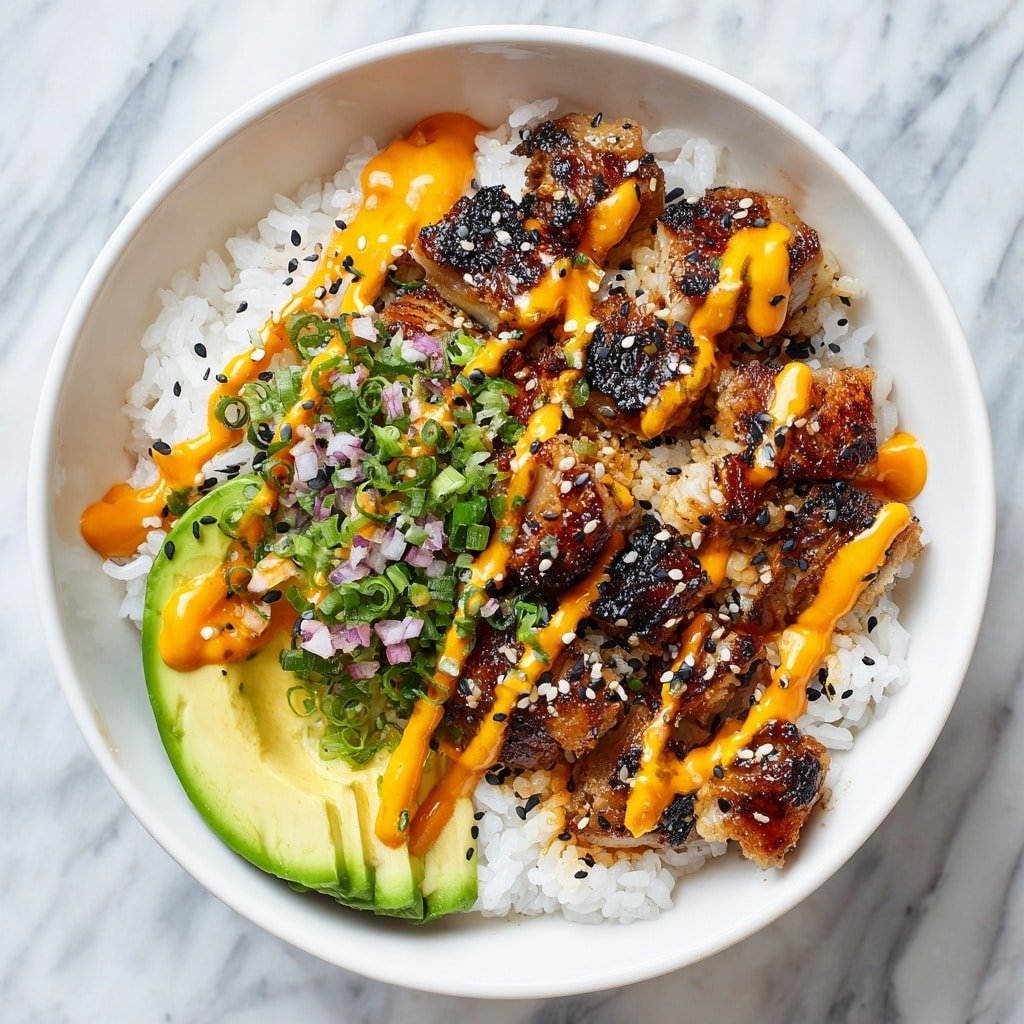 A white bowl holds a dish with three main layers. The bottom layer is white sticky rice, soft and fluffy. On top of the rice is a layer of small, light brown grilled pieces of fish or seafood with a slightly charred texture. Over this, drizzled orange sauce spreads unevenly, creating bright, creamy streaks. Sprinkled across the dish are black sesame seeds and small pink bits, adding contrast. In the center, green chopped scallions are scattered for color and freshness. A green avocado slice rests on the side inside the bowl. The bowl is placed on a white marbled surface. Photo taken with an iphone --ar 1:1 --v 7 — Spicy Crab Sushi Bowls, sushi bowls with crab, easy sushi bowl recipe, seafood rice bowls, spicy crab salad